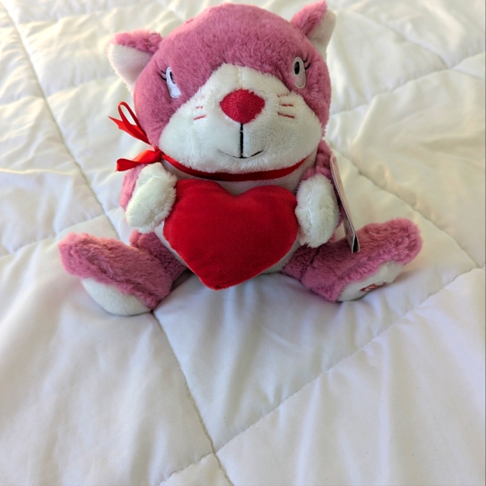 Hallmark plush pink cat holding a heart. 8 inches approximately. EUC. has tags.